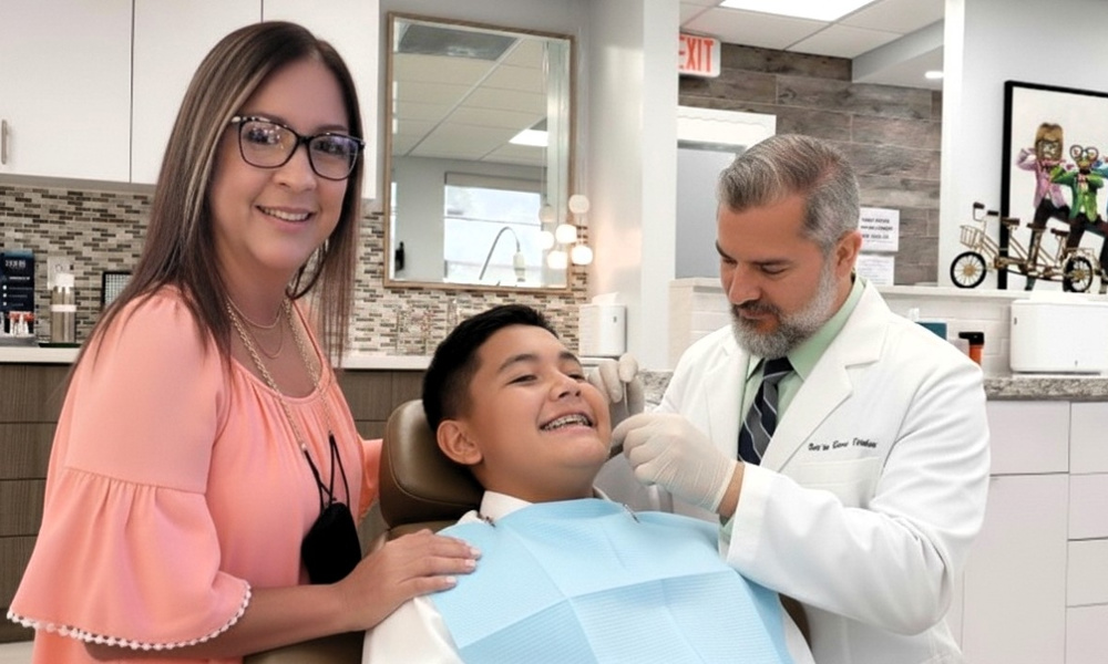 Dr. Martinez providing personalized orthodontic care to a smiling young patient at Martinez Orthodontics in Miami, demonstrating our commitment to professional and compassionate clinical excellence.